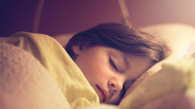 Little girl sleeping in her bed 