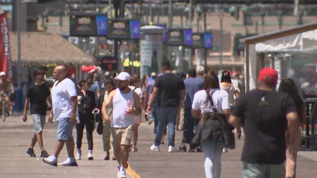 Crowds walk on the Atlantic City boardwalk 